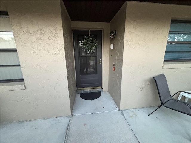 doorway to property with stucco siding