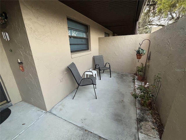 view of patio / terrace featuring fence