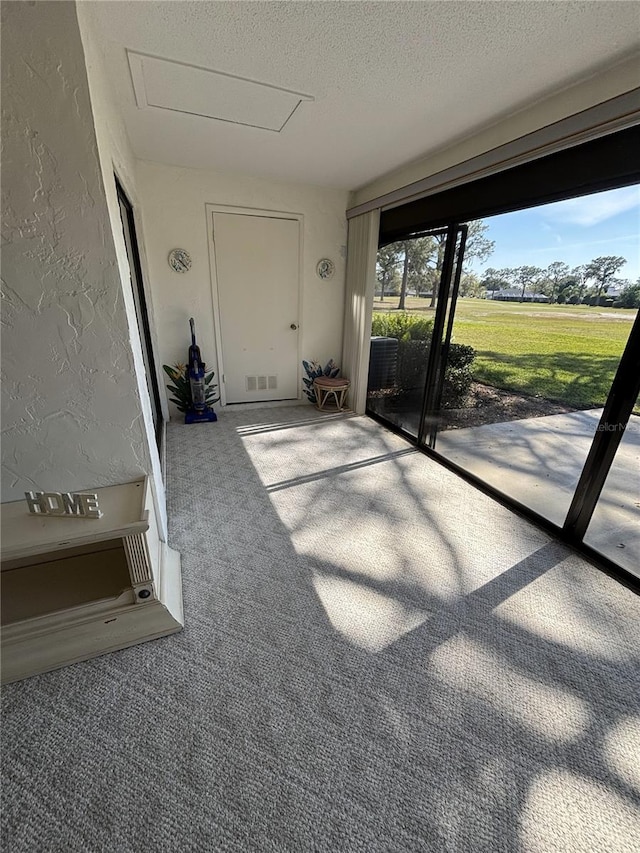 exterior space with a textured ceiling and a textured wall