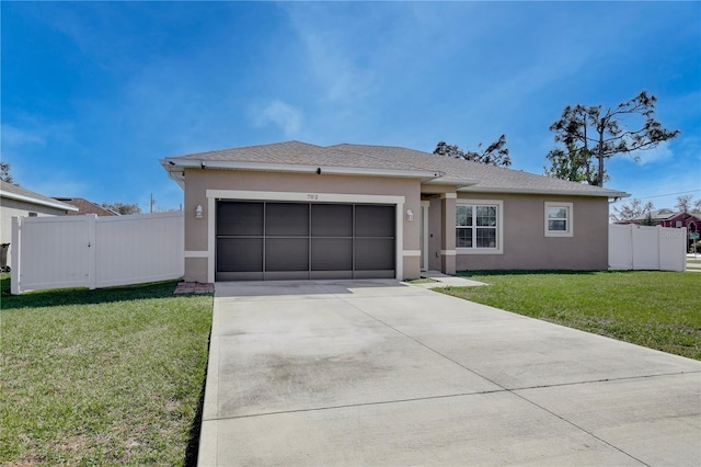 view of front of house featuring a front lawn and a garage