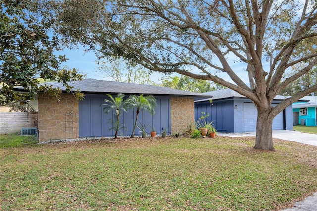 single story home with a front yard, a garage, and cooling unit