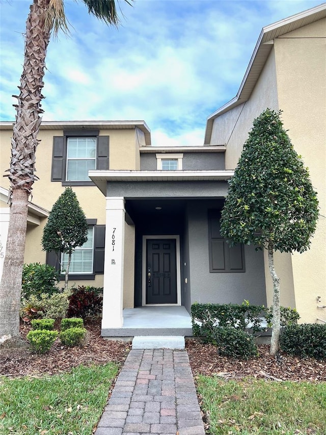 property entrance featuring stucco siding