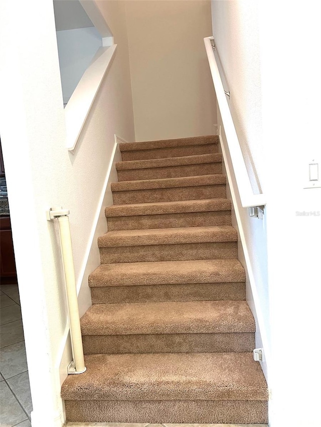 stairs with tile patterned flooring