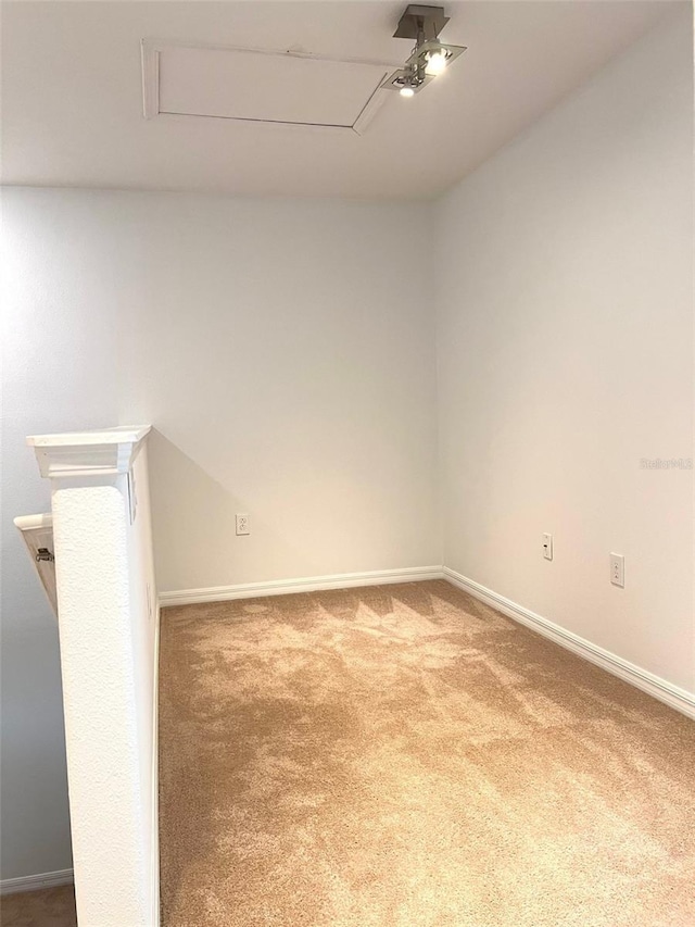 spare room featuring carpet and baseboards