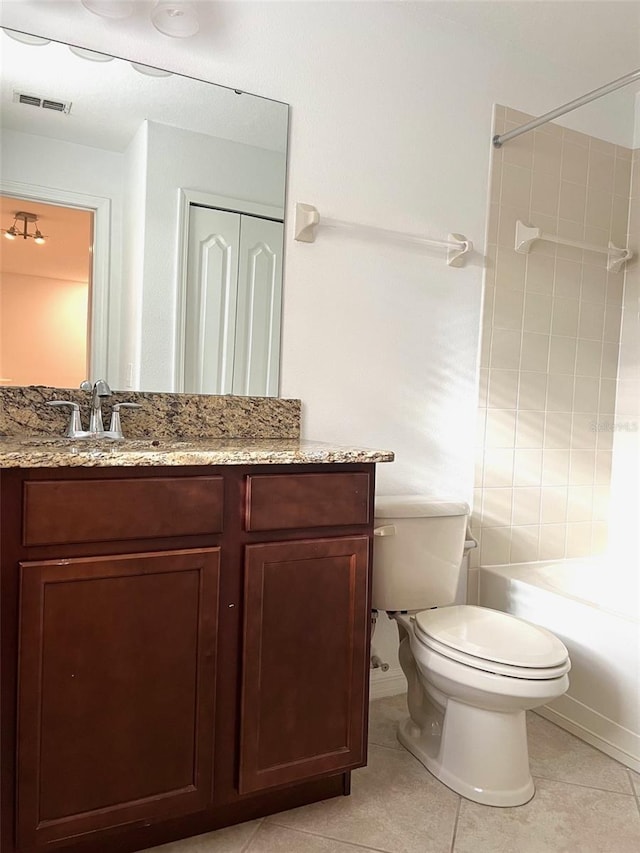 bathroom with toilet, vanity, visible vents, a closet, and tile patterned floors