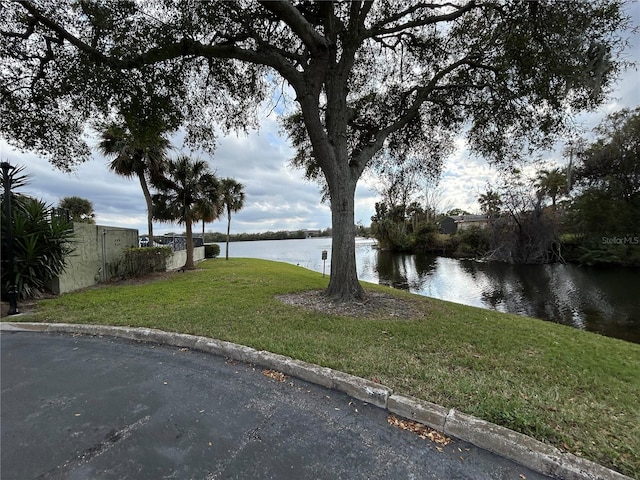 view of yard with a water view and fence