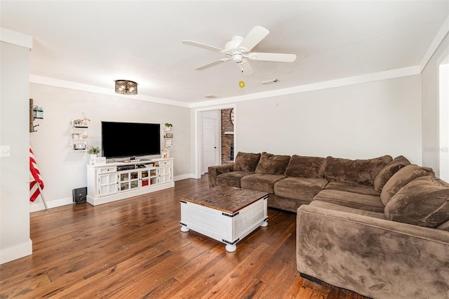 living room featuring crown molding, visible vents, hardwood / wood-style floors, ceiling fan, and baseboards