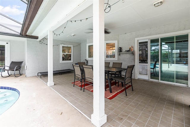 view of patio featuring glass enclosure and outdoor dining space