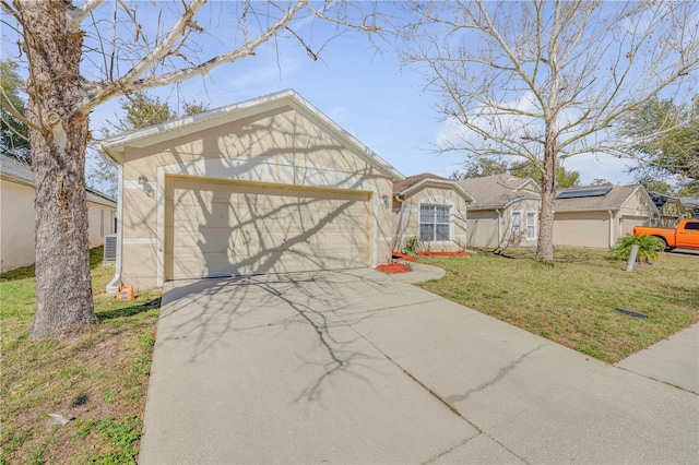 single story home featuring concrete driveway, stucco siding, an attached garage, and a front yard