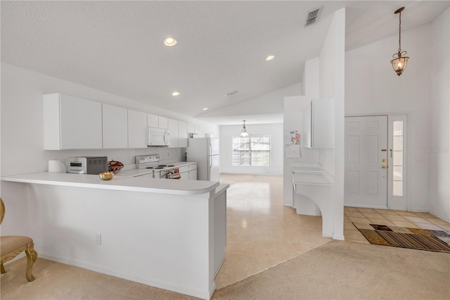 kitchen featuring white appliances, visible vents, light countertops, and light colored carpet