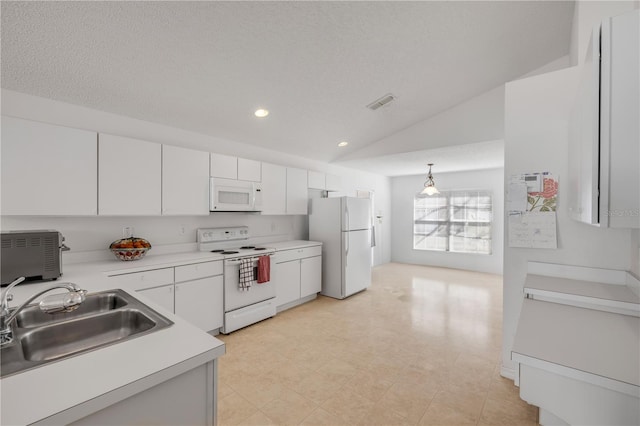 kitchen featuring white appliances, white cabinets, vaulted ceiling, light countertops, and a sink