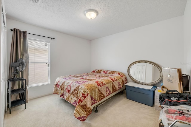 bedroom featuring carpet and a textured ceiling