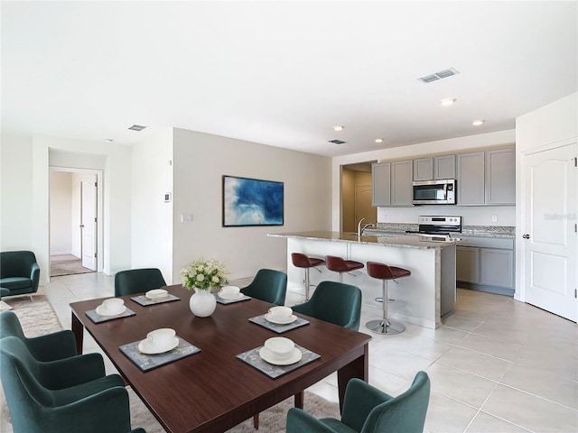 dining space featuring recessed lighting, visible vents, and light tile patterned floors