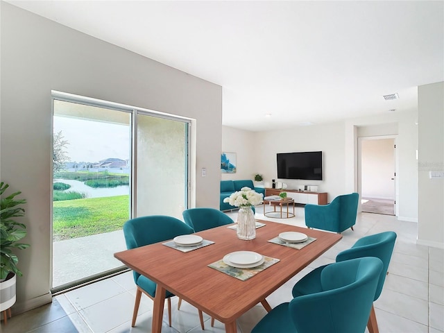 dining room with visible vents, baseboards, and light tile patterned floors