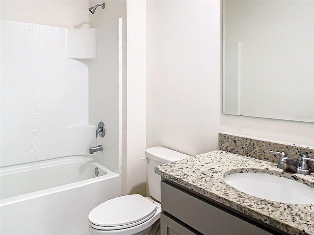 full bathroom featuring toilet, washtub / shower combination, and vanity