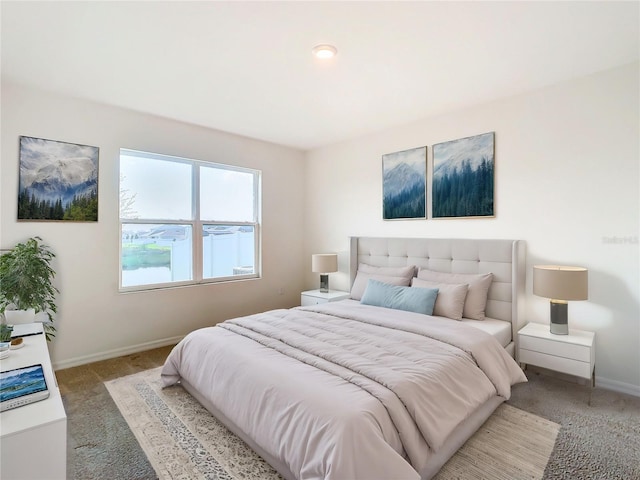 bedroom featuring light carpet and baseboards