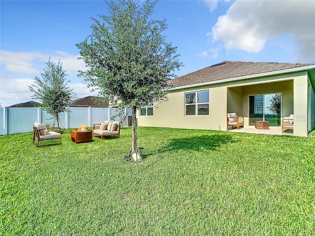 view of yard featuring an outdoor living space with a fire pit, fence, and a patio