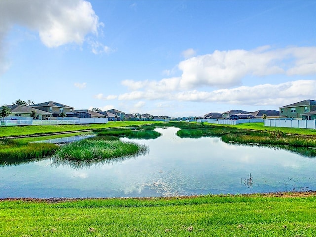 property view of water with fence and a residential view