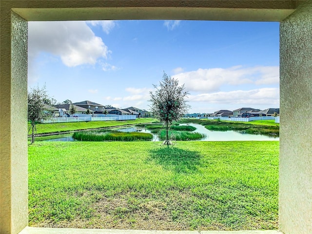 view of yard featuring a water view and a residential view