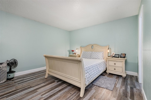 bedroom featuring dark hardwood / wood-style flooring