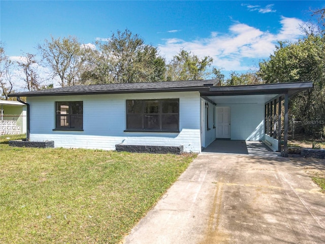 ranch-style home featuring a carport and a front yard