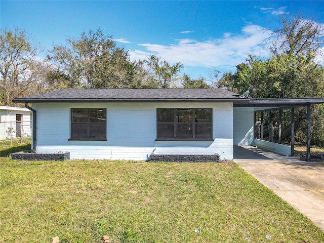 view of front facade with a front yard and a carport