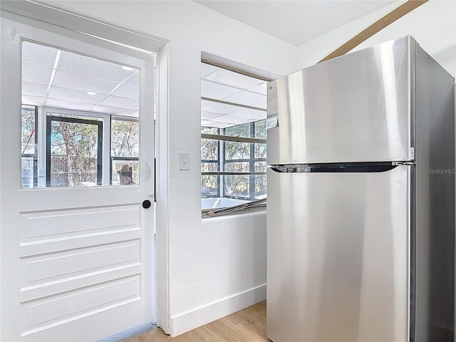 doorway to outside with light wood-type flooring and a healthy amount of sunlight