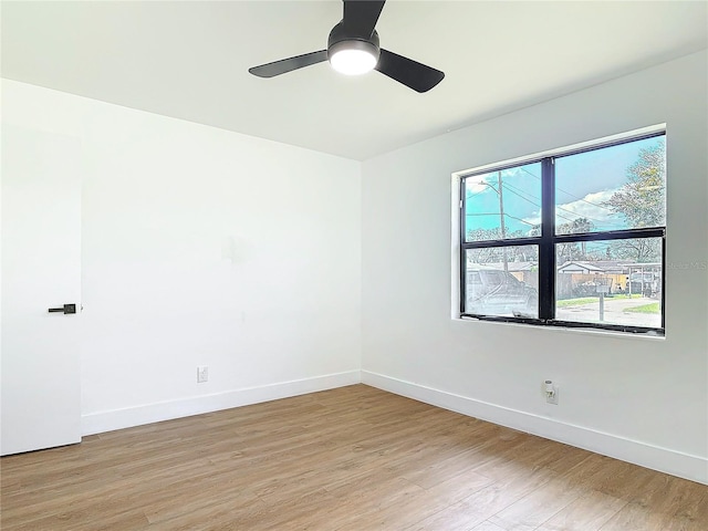 empty room with light hardwood / wood-style flooring and ceiling fan