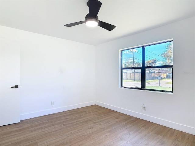 empty room with ceiling fan and wood-type flooring