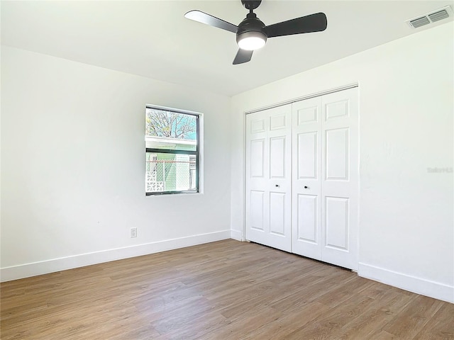 unfurnished bedroom featuring a closet, ceiling fan, and light hardwood / wood-style flooring