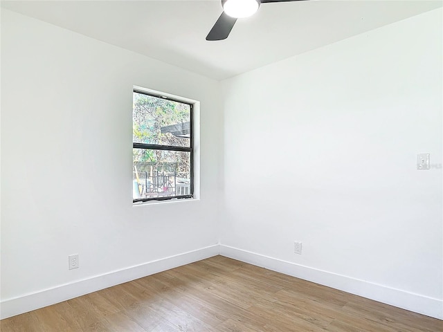 unfurnished room with ceiling fan and wood-type flooring