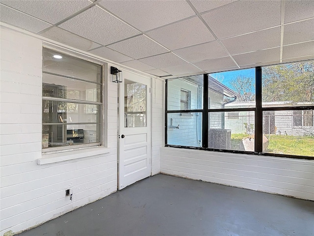 unfurnished sunroom featuring a paneled ceiling