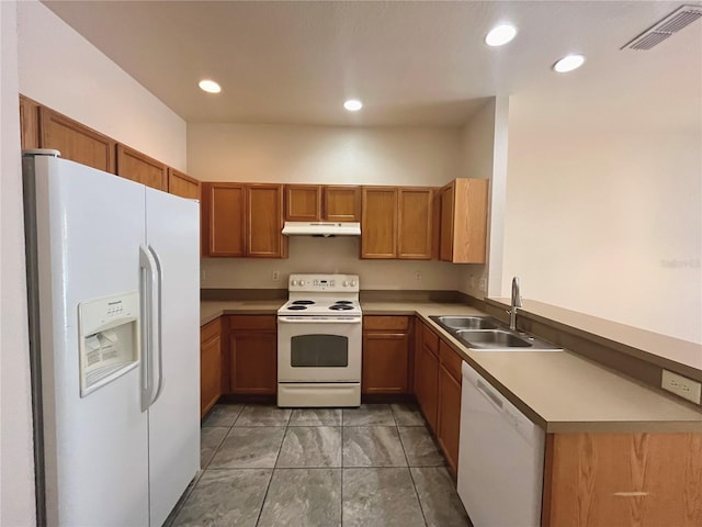 kitchen featuring under cabinet range hood, white appliances, a sink, visible vents, and light countertops