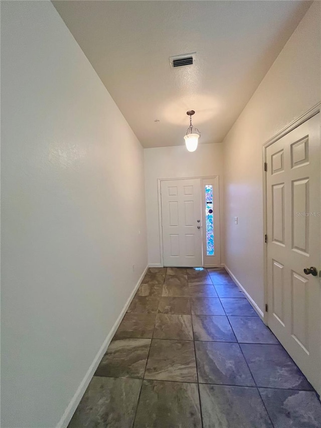 doorway to outside featuring visible vents and baseboards