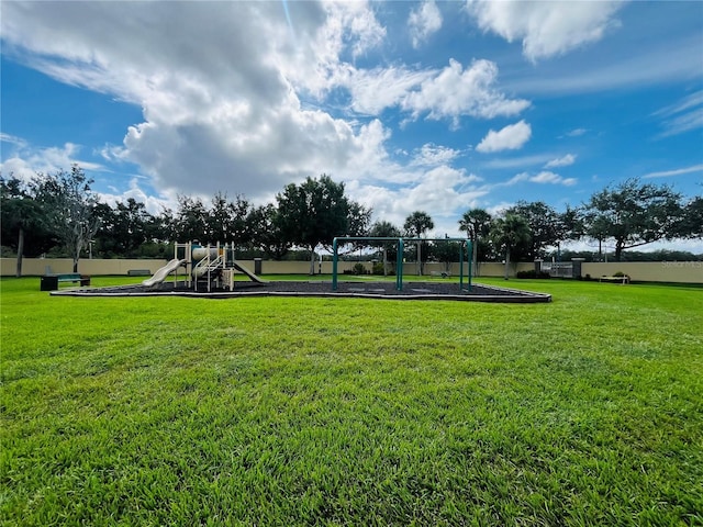 surrounding community with playground community and a yard