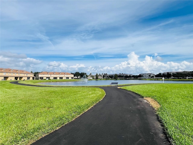 view of road featuring a water view and a residential view