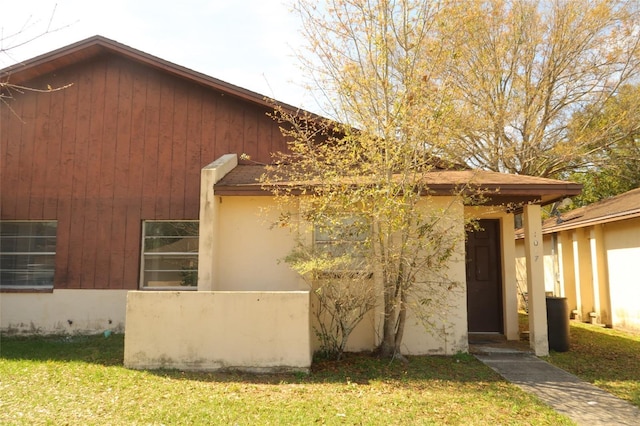 view of home's exterior with a lawn