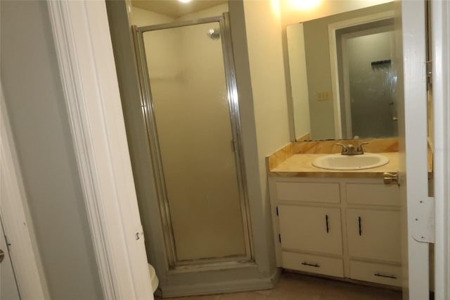 full bathroom featuring a shower stall, vanity, and tile patterned floors