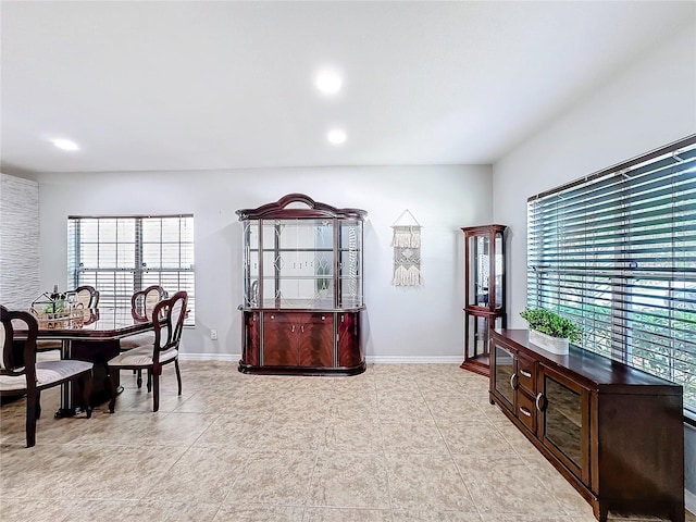 interior space featuring light tile patterned floors, recessed lighting, and baseboards