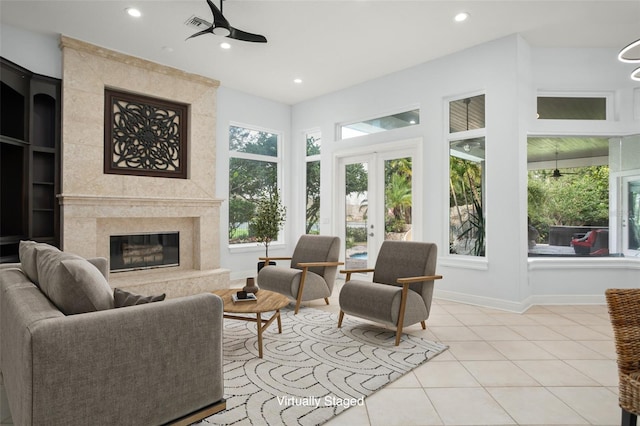 interior space with recessed lighting, a high end fireplace, light tile patterned flooring, ceiling fan, and baseboards