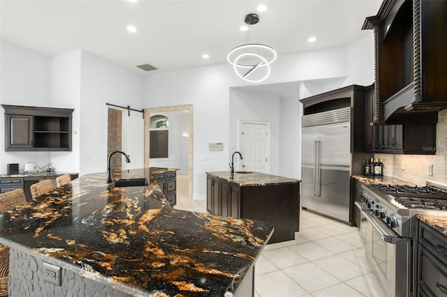 5138 Fairway Oaks Dr, Windermere, FL 34786 - kitchen with a barn door, premium appliances, a large island with sink, open shelves, and a sink
