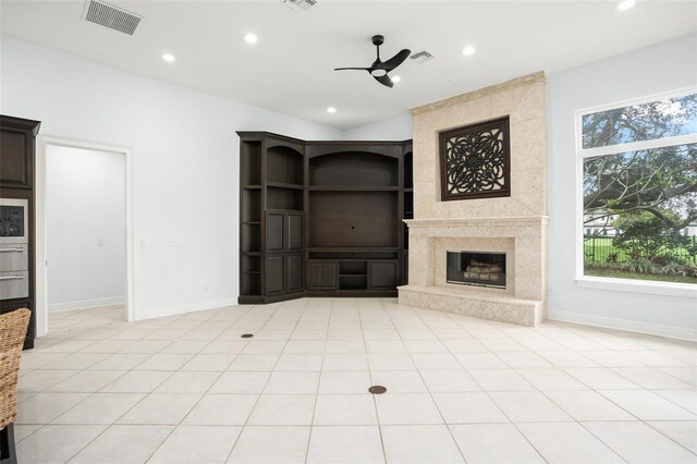 5138 Fairway Oaks Dr, Windermere, FL 34786 - unfurnished living room featuring a healthy amount of sunlight, recessed lighting, visible vents, and a high end fireplace