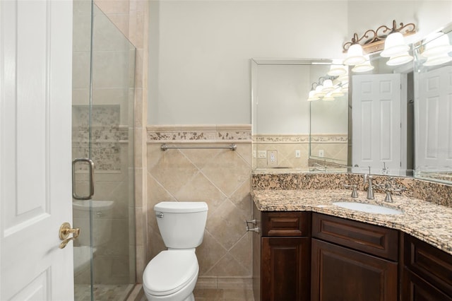 5138 Fairway Oaks Dr, Windermere, FL 34786 - bathroom with toilet, a wainscoted wall, vanity, a shower stall, and tile walls