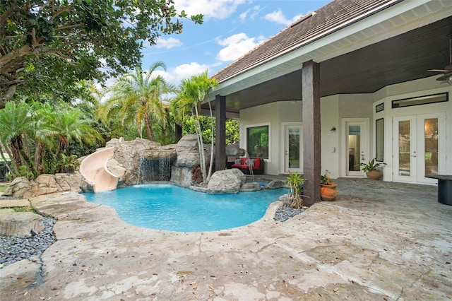 5138 Fairway Oaks Dr, Windermere, FL 34786 - outdoor pool with a water slide, ceiling fan, a patio, and french doors