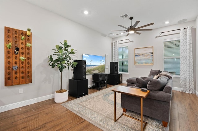 living room featuring hardwood / wood-style floors and ceiling fan