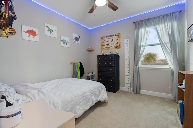 bedroom with ceiling fan and light colored carpet