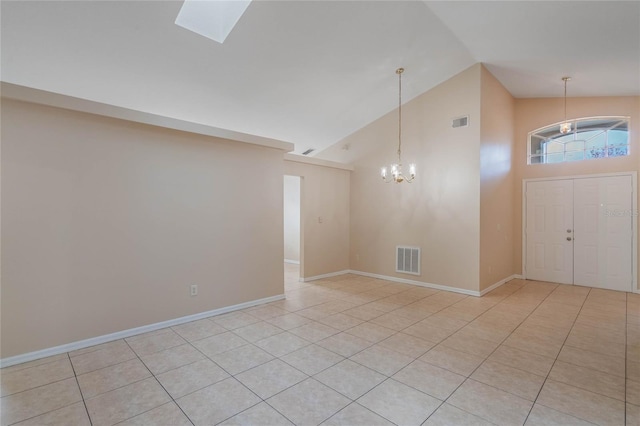 foyer featuring high vaulted ceiling, visible vents, and light tile patterned flooring