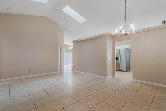 unfurnished room with a skylight, baseboards, light tile patterned floors, and visible vents