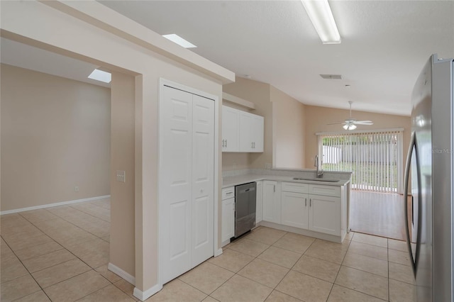 kitchen featuring stainless steel appliances, light countertops, white cabinets, and a sink