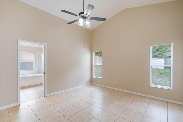 empty room featuring light tile patterned floors, plenty of natural light, a ceiling fan, and baseboards